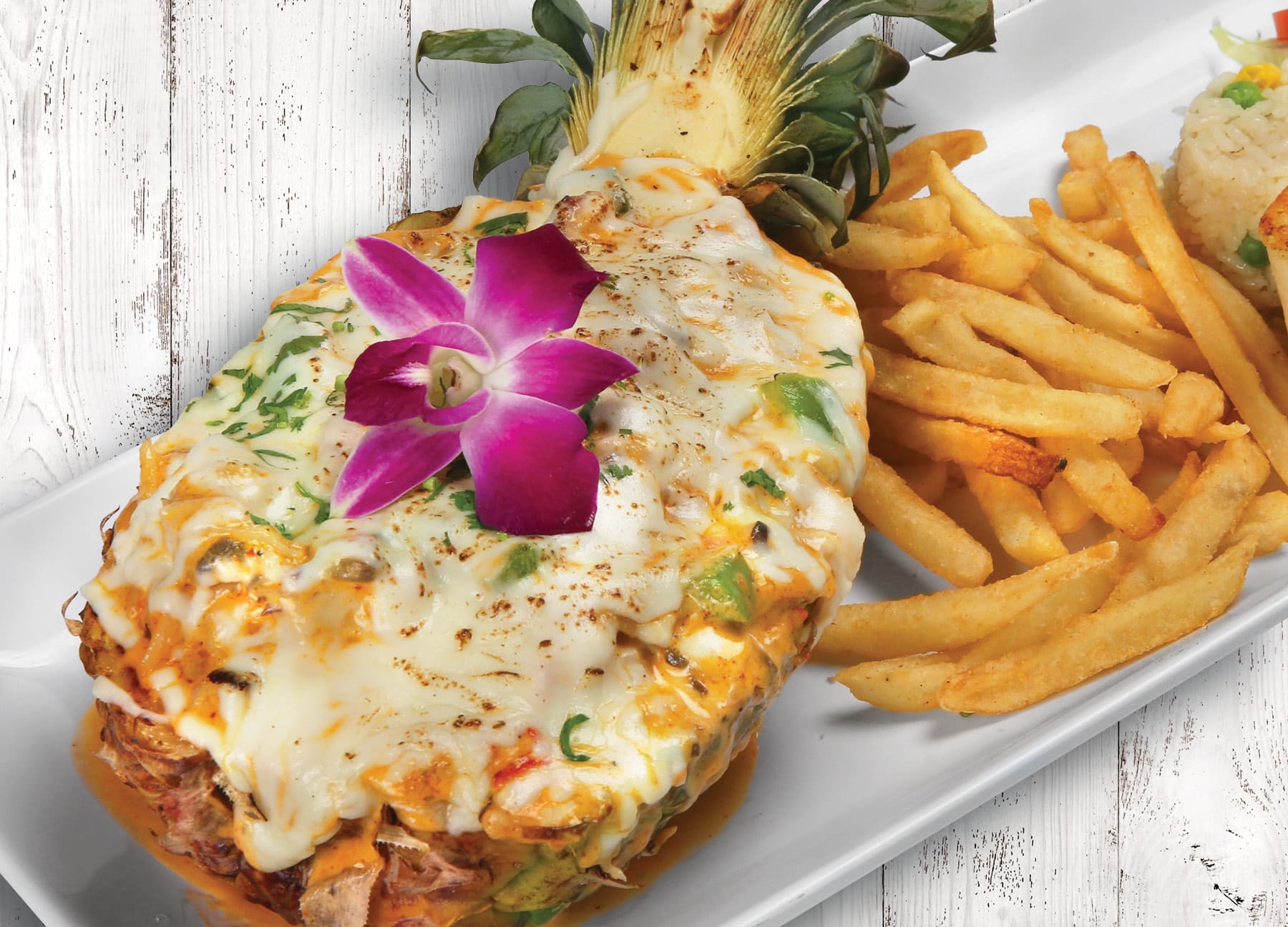 Seafood-stuffed pineapple with melted cheese at Villas Pueblita Mexican Restaurant in Indianapolis, IN